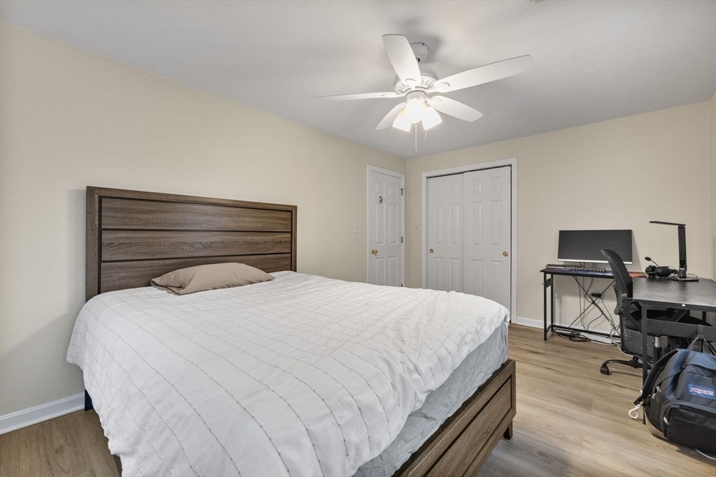 13 Plain Street Upton, MA 01568 - Photo 18 of 27 a bedroom with a bed and a chandelier