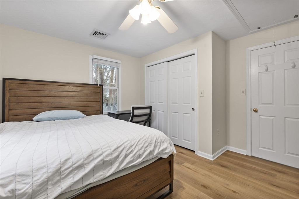 13 Plain Street Upton, MA 01568 - Photo 21 of 27 a bedroom with a bed and a chandelier