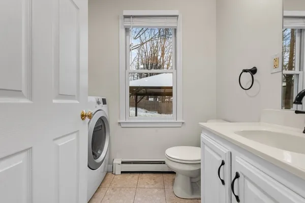 a bathroom with a sink a washer and dryer
