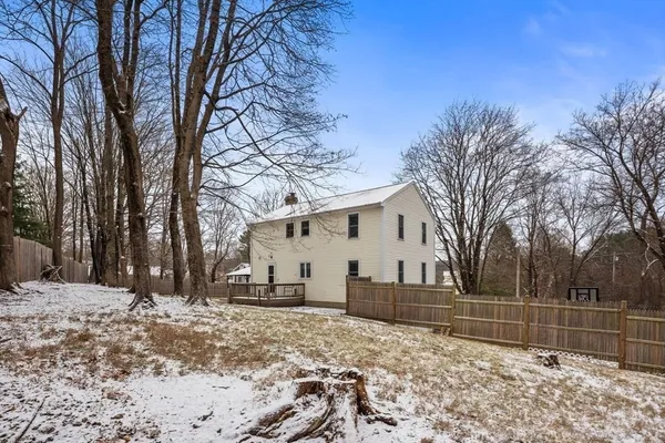 a view of a white house with a snow in the yard