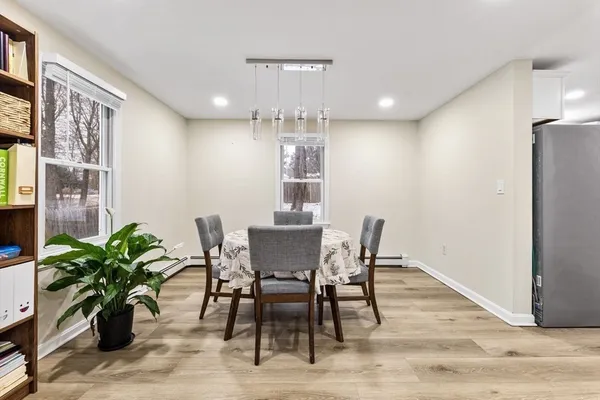 a view of a dining room with furniture and a potted plant
