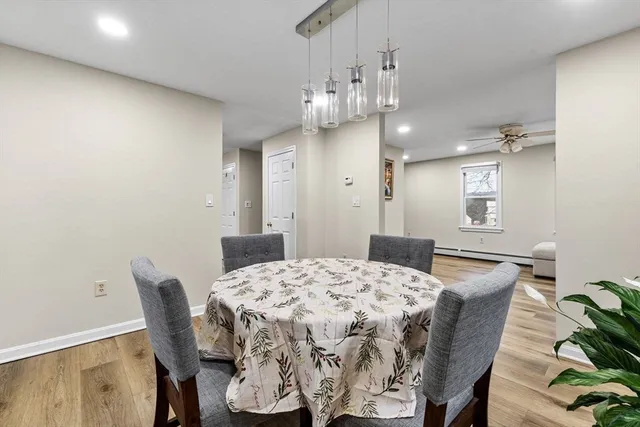 a dining room with furniture and chandelier