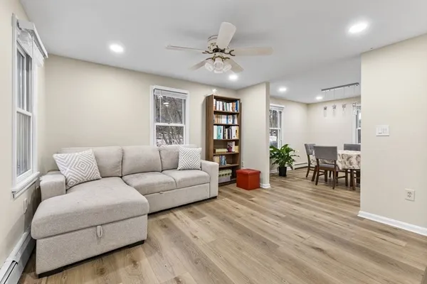 a living room with furniture and wooden floor