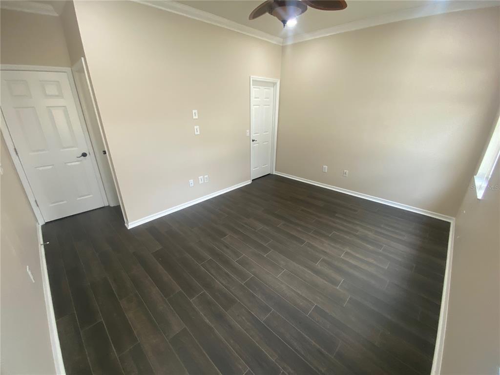 2409 Spring Hollow Loop Wesley Chapel, FL 33544 - Photo 20 of 47 an empty room with wooden floor and entryway