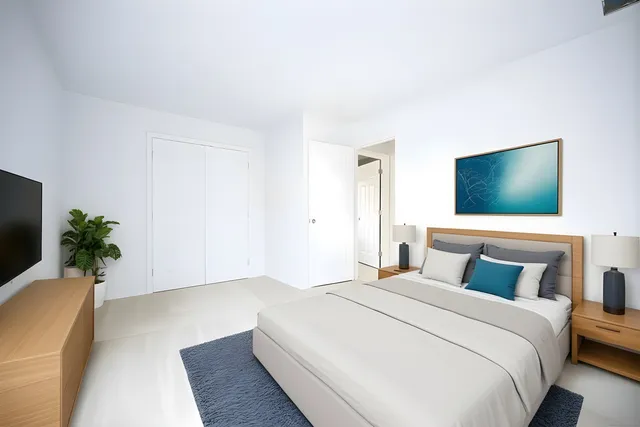 a bedroom with a bed and a flat screen tv