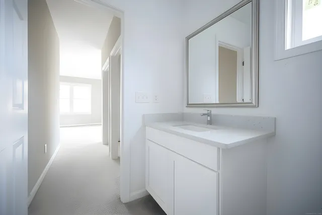 a bathroom with a sink a vanity and a mirror