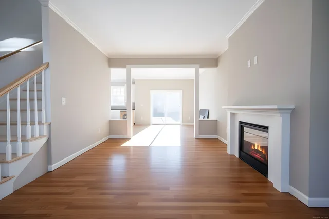 a view of an empty room with a fireplace and a window