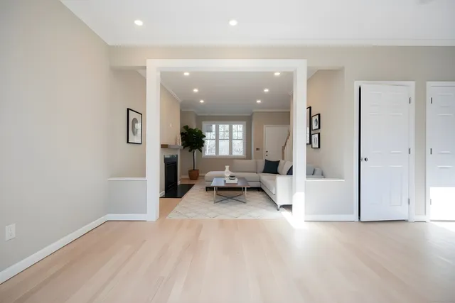 an entryway and livingroom with furniture