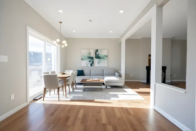 a living room with furniture wooden floor and a table