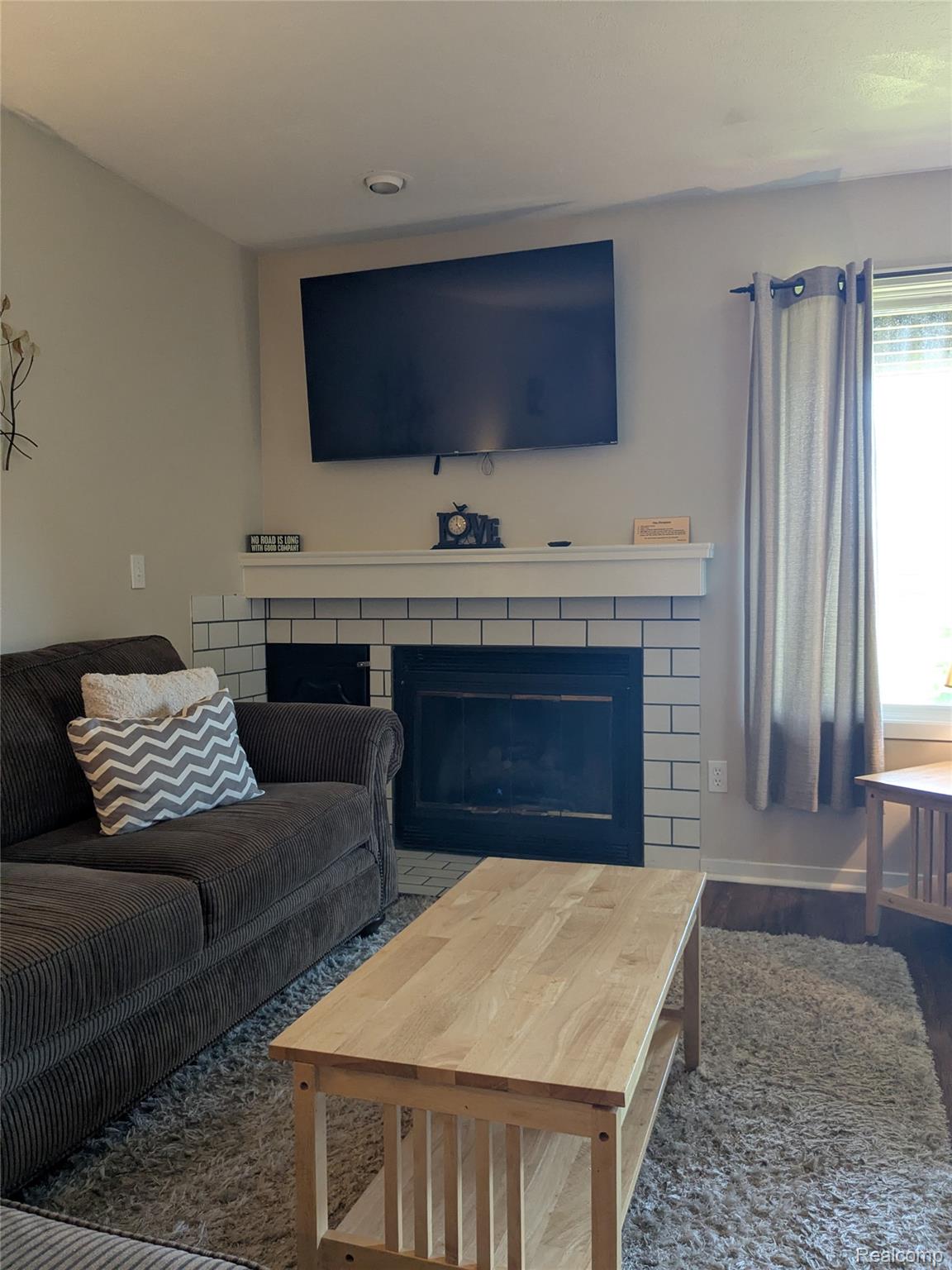 4749 South Pleasantview Road, Unit 37 Harbor Springs, MI 49740 - Photo 18 of 44 Living Room with New Vinyl Flooring and Natural Fireplace
