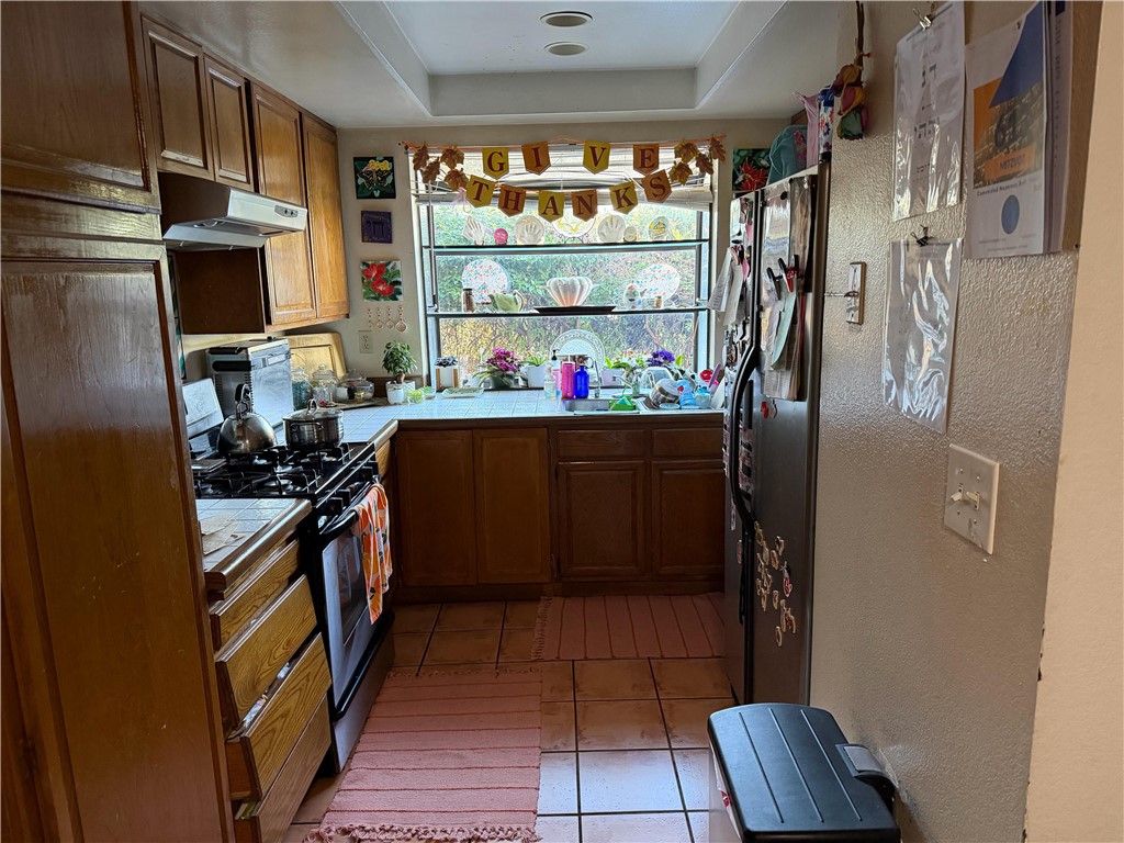 5345 Peck Road, Unit B El Monte, CA 91732 - Photo 5 of 17 a kitchen with stainless steel appliances granite countertop a refrigerator and a stove