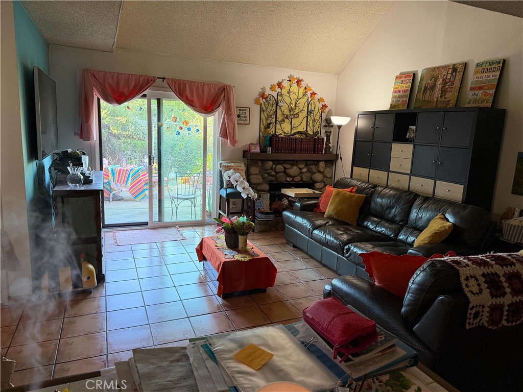 5345 Peck Road, Unit B El Monte, CA 91732 - Photo 6 of 17 a living room with furniture fireplace and a floor to ceiling window
