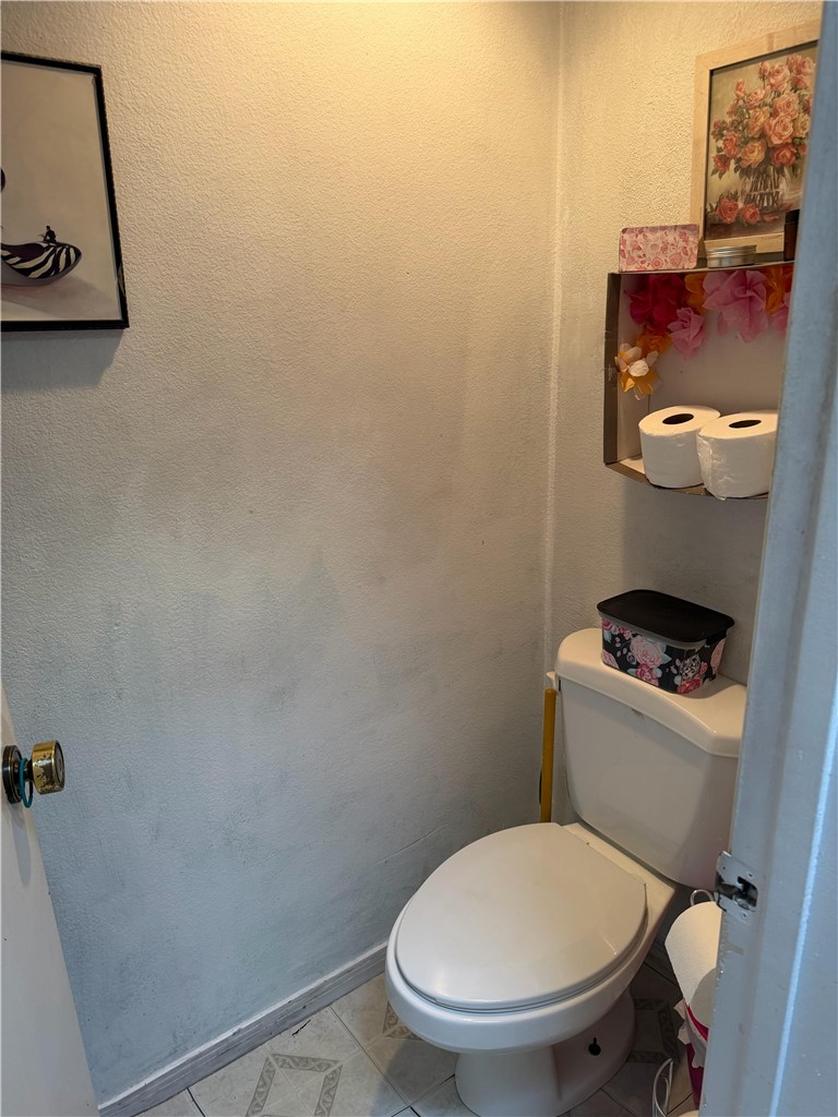 5345 Peck Road, Unit B El Monte, CA 91732 - Photo 9 of 17 a white toilet sitting next to a small sink