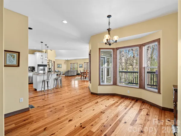 a view of a room with wooden floor and windows