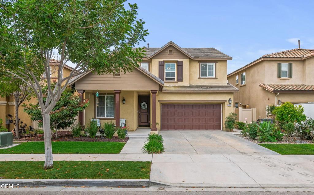 652 Xanadu Way Oxnard, CA 93036 - Photo 1 of 40 a front view of a house with a yard and potted plants