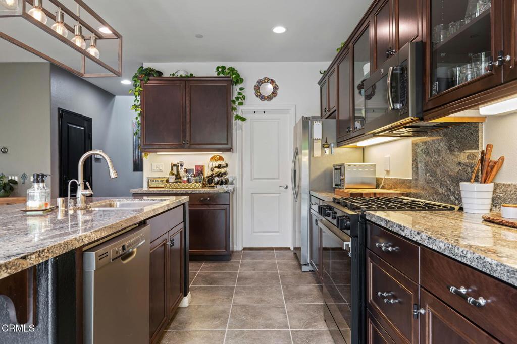 652 Xanadu Way Oxnard, CA 93036 - Photo 14 of 40 a kitchen with stainless steel appliances granite countertop a stove and a sink