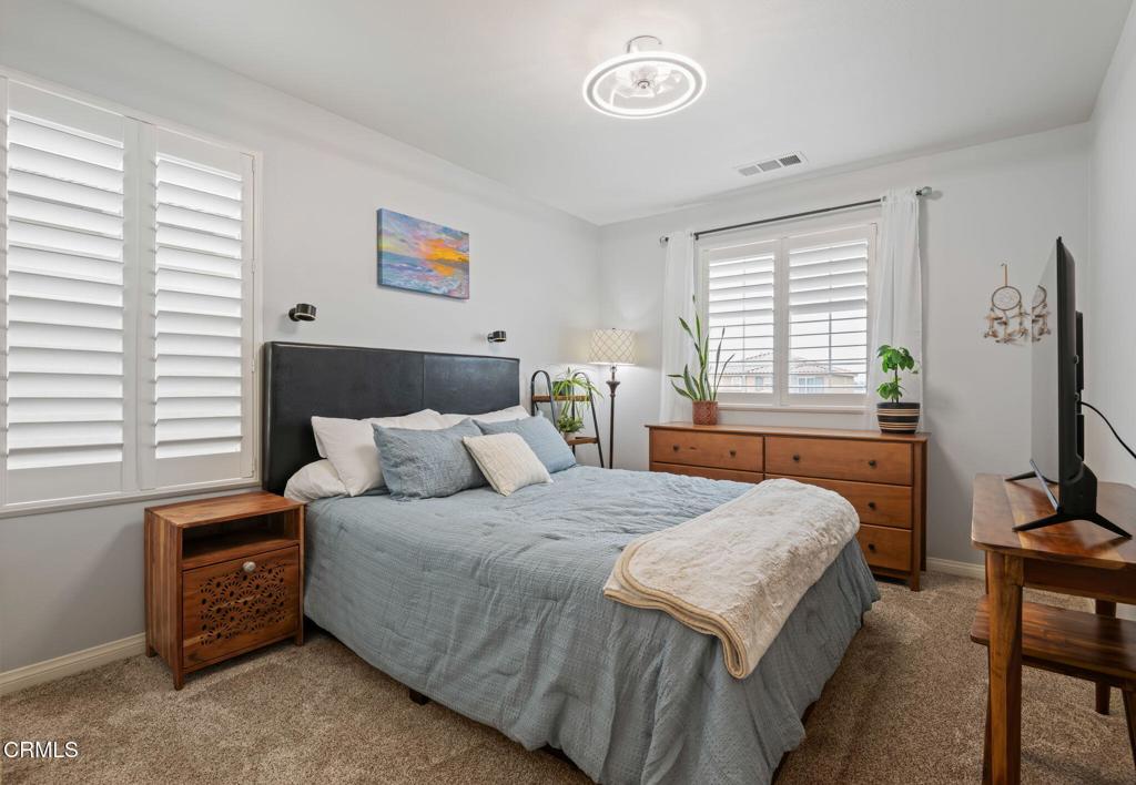 652 Xanadu Way Oxnard, CA 93036 - Photo 26 of 40 a bedroom with a bed and a table