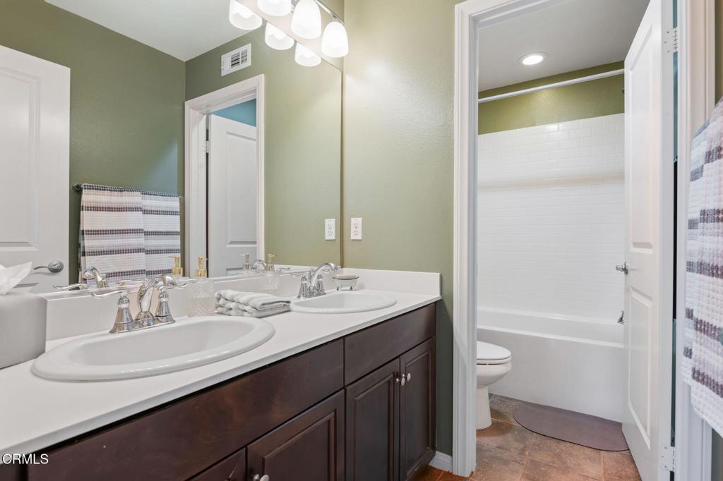 652 Xanadu Way Oxnard, CA 93036 - Photo 28 of 40 a bathroom with a sink double vanity granite tub and a mirror