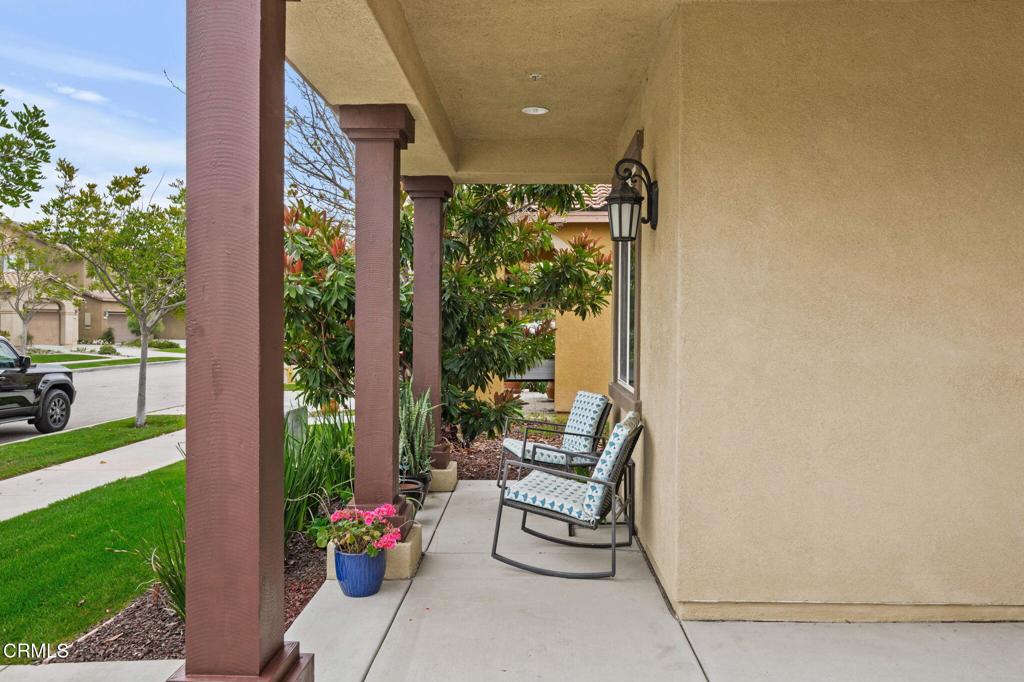 652 Xanadu Way Oxnard, CA 93036 - Photo 3 of 40 a porch with a bench and potted plants