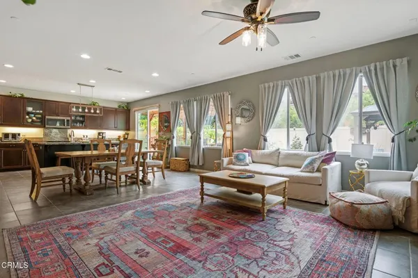 a living room with furniture a rug and a flat screen tv