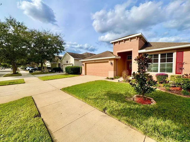 a front view of a house with a yard and a garage