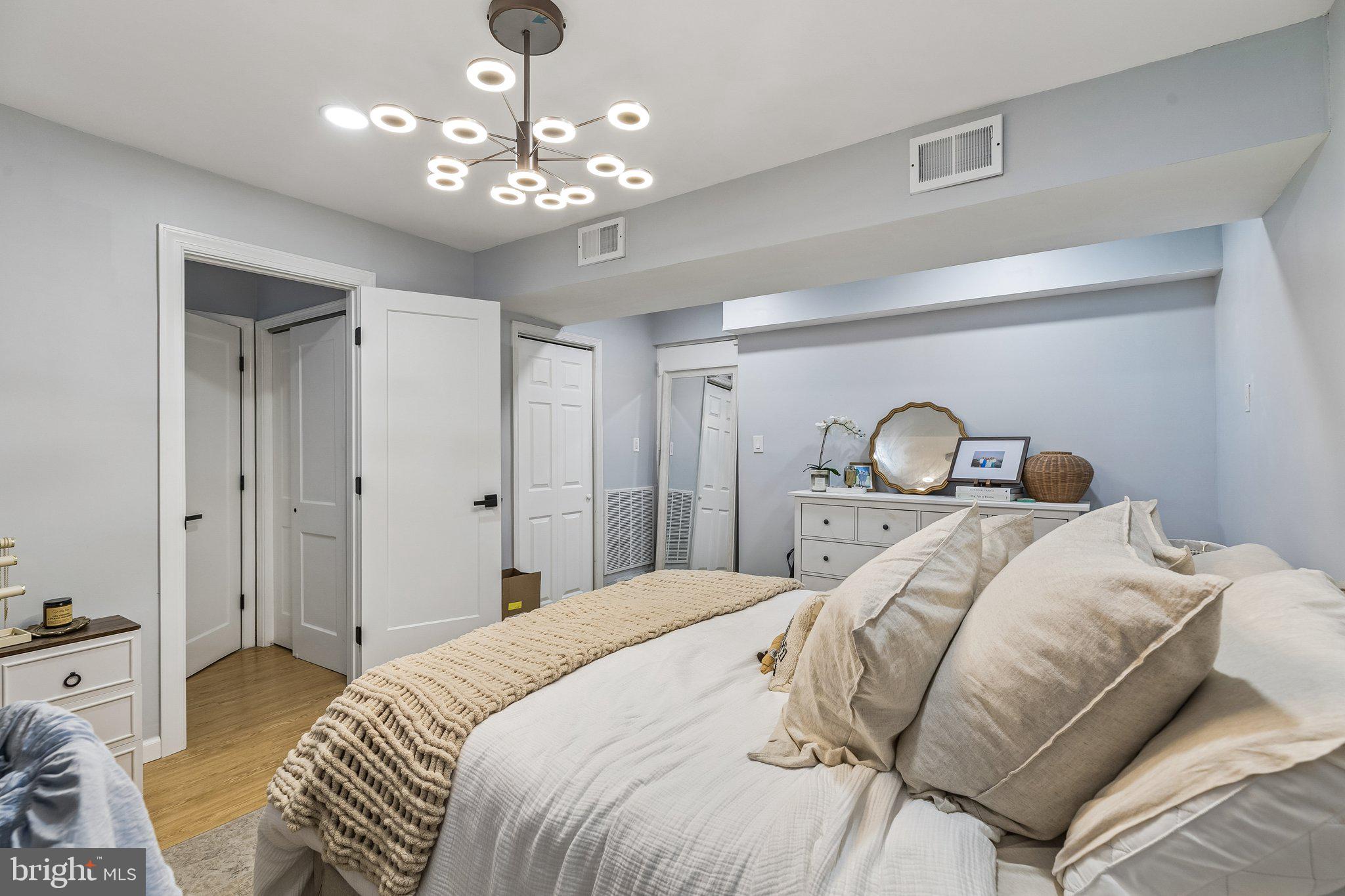 1130 Lombard Street Philadelphia, PA 19147 - Photo 36 of 45 a bedroom with a bed and chandelier