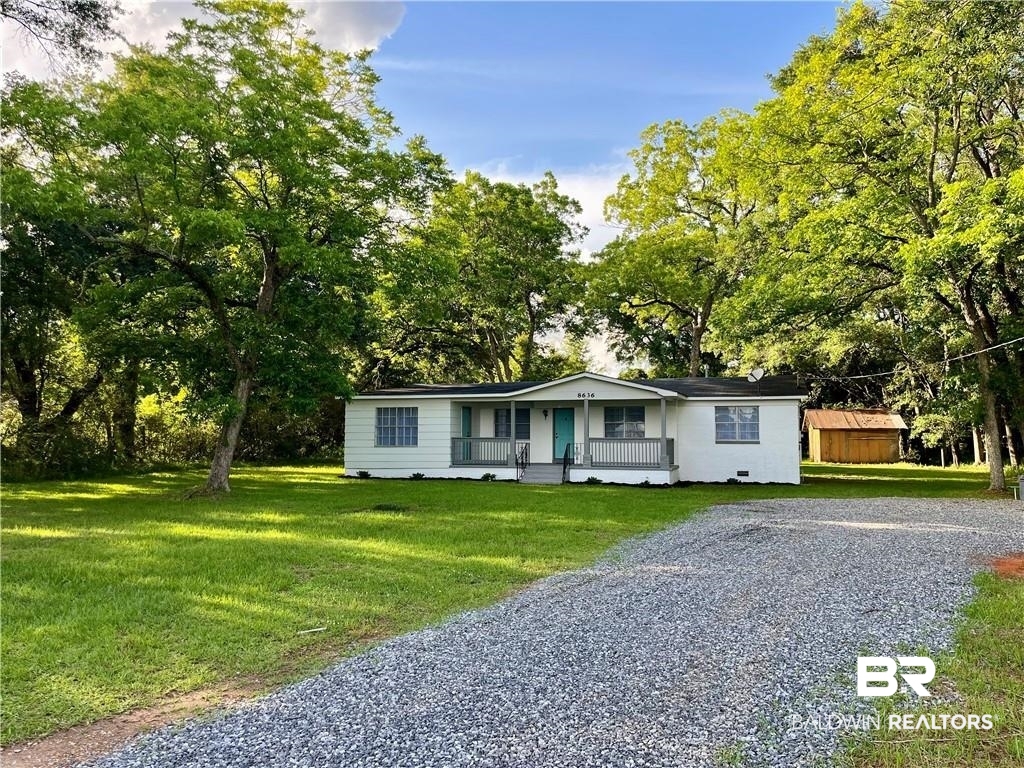 8636 Boe Road Irvington, AL 36544 - Photo 1 of 22 Ranch-style home with a front yard, view of scattered trees, and covered porch