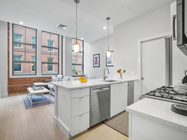 a kitchen that has a sink and a stove in it