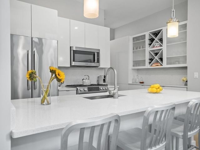 a kitchen with a sink a stove and appliances