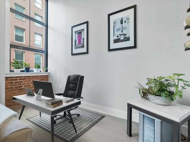 a work room with furniture and a potted plant