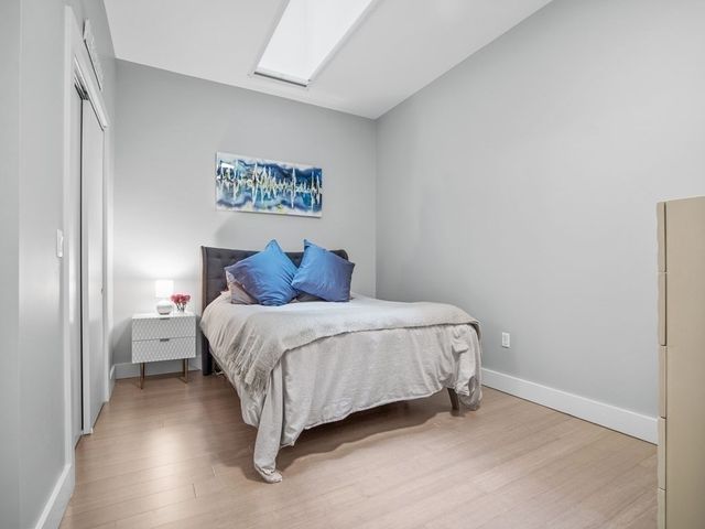 a bedroom with a bed and a wall painting