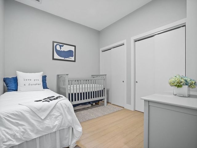 a bedroom with a bed and a potted plant