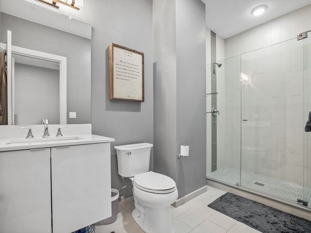 a bathroom with a toilet a sink and shower