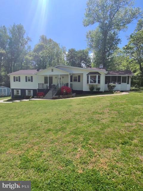 12601 Livingston Road Fort Washington, MD 20744 - Photo 26 of 26 a house that is sitting in the grass with large trees and plants