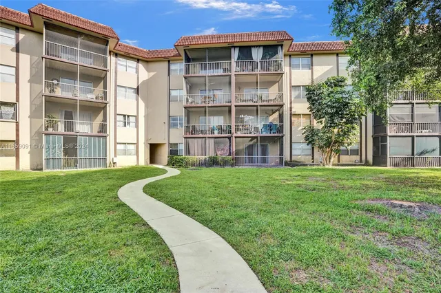 a view of a house with a garden and plants