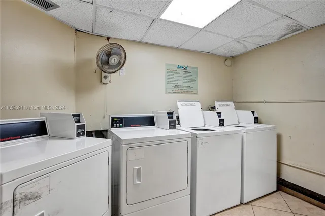 a view of washer and dryer with kitchen in the background