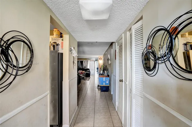 a view of a hallway with a washer and dryer