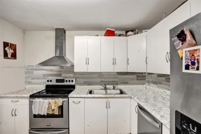 a kitchen with a stove and cabinets