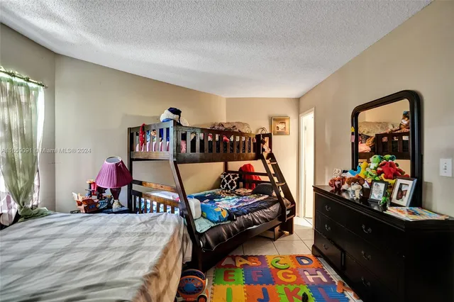 a bedroom with bed and a couch