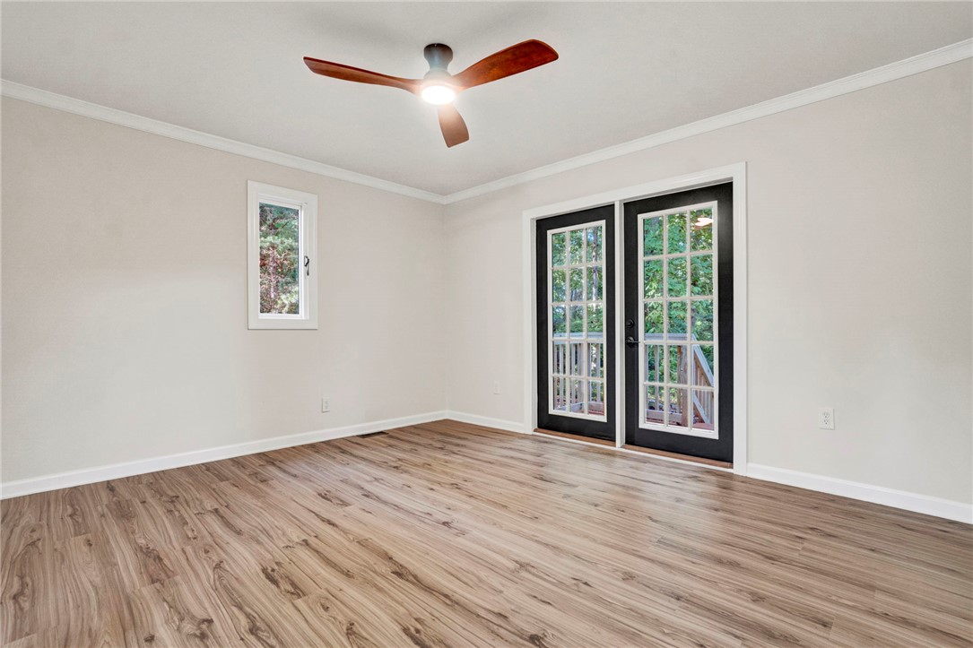 237 Earle Road Central, SC 29630 - Photo 14 of 24 Natural light floods this room, highlighting the clean, modern flooring and outdoor access.