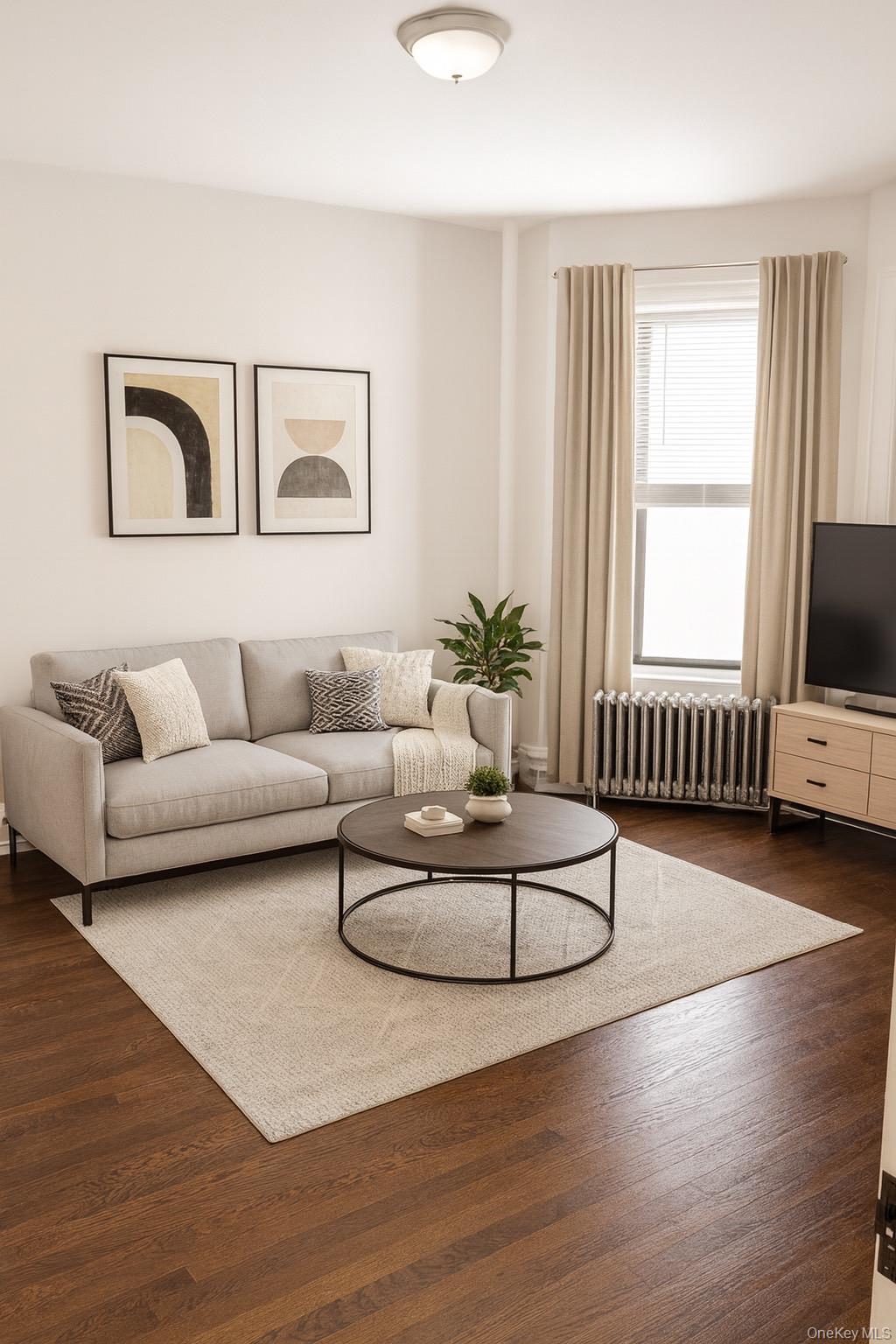740 South Oak Drive Bronx, NY 10467 - Photo 1 of 4 a living room with furniture and a flat screen tv