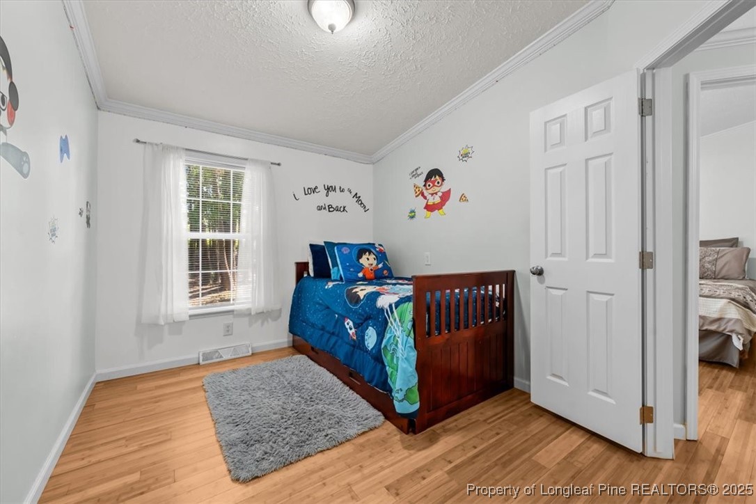 11891 Aberdeen Road Aberdeen, NC 28315 - Photo 24 of 35 a bedroom with a bed and a window