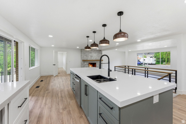871 Bonita Way Centerville, UT 84014 - Photo 1 of 61 Kitchen island featuring a white countertop, undermount sink, and matte black faucet