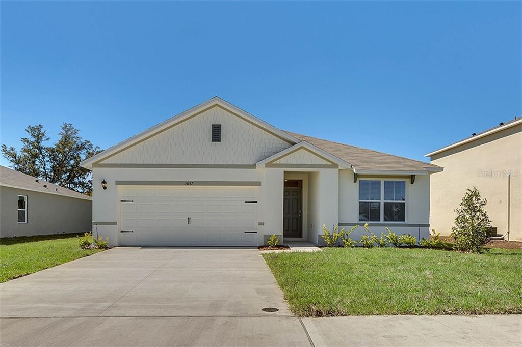 1112 Fox Path Road Davenport, FL 33837 - Photo 1 of 1 a front view of house with a garden