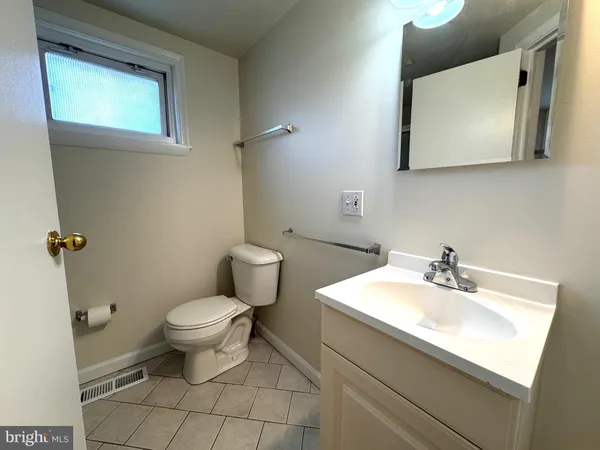 a bathroom with a sink toilet and mirror