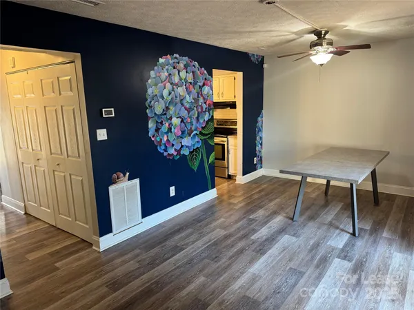 a view of a livingroom with furniture window and wooden floor