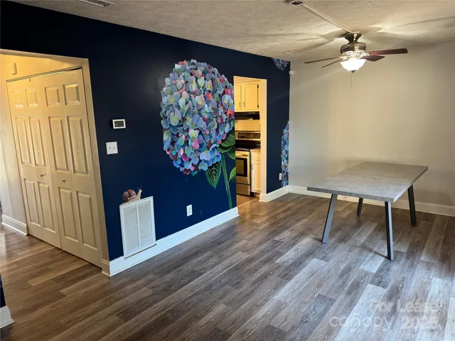 a view of a livingroom with furniture window and wooden floor