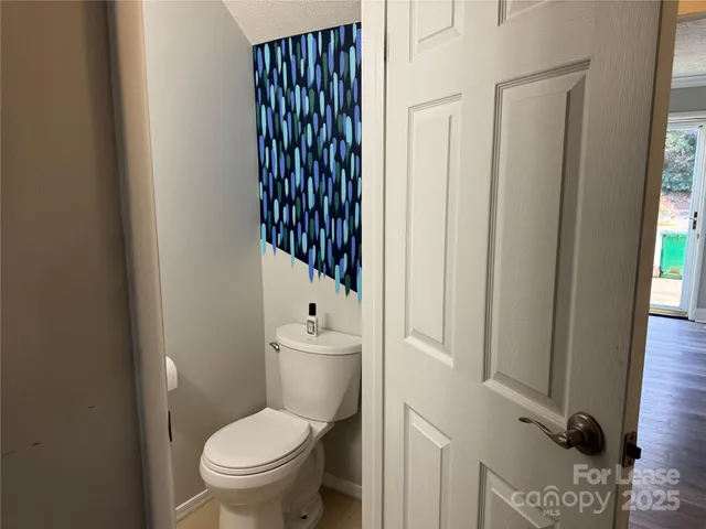 a white toilet sitting next to a bathroom sink