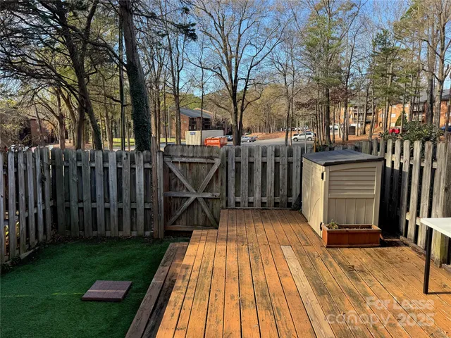 a view of backyard with barbeque grill and outdoor seating