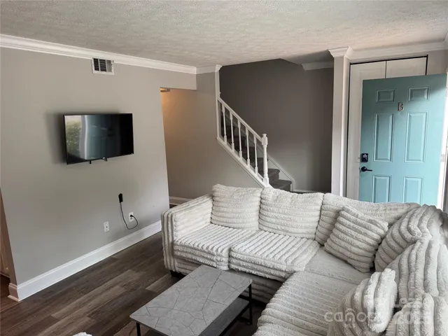 a living room with couches and a flat screen tv